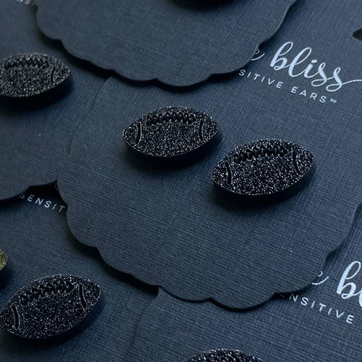 black glitter football earrings